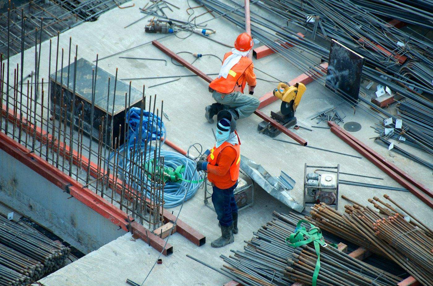 Aerial view of workers fixing reinforcement on a concrete slab